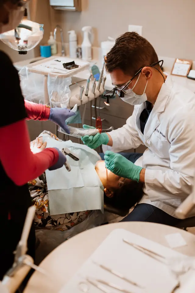 Dr. Kirk McKibben and an assistant treating a young patient at Defiance Dental Group
